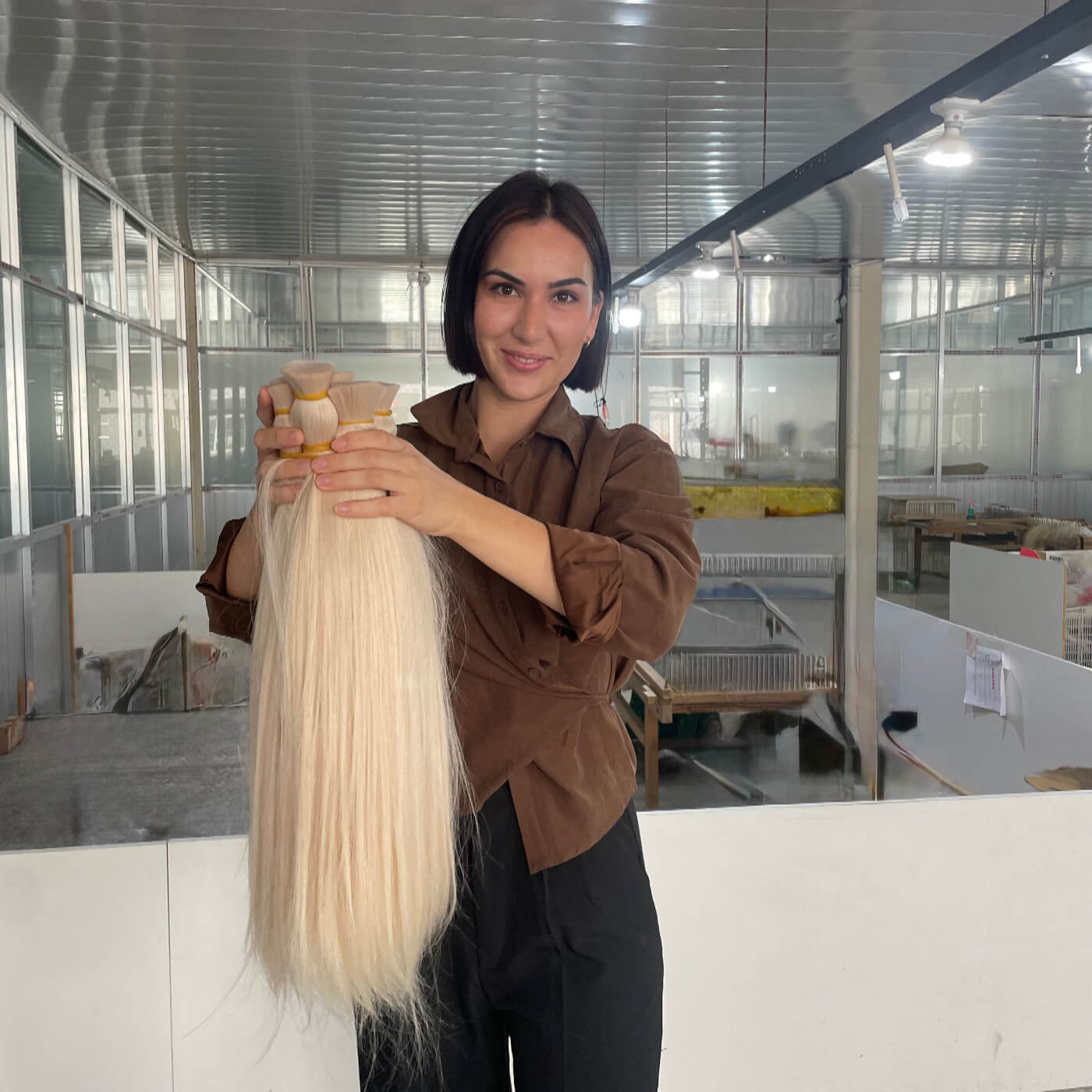 Owner of Sophia Hair Holding hair extensions in hair factory